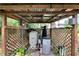Water equipment system housed in a covered outdoor area with a wooden lattice surround at 1406 Butch Cassidy Trl, Wimauma, FL 33598