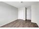 Bedroom with wood-look flooring, closet, and white door at 14403 Dunrobin Dr, Wimauma, FL 33598