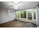 Spacious sunroom featuring a ceiling fan and garden views at 1526 Oakwood St, Clearwater, FL 33755