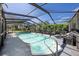 Relaxing screened-in pool with lounge chairs at 15933 Adobe Dr, Hudson, FL 34667