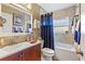 Clean bathroom featuring a bathtub, vanity, and blue shower curtain at 1625 Leisure Dr, Clearwater, FL 33756