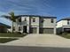 Two-story house with gray exterior, two-car garage, and landscaping at 16615 Parker River St, Wimauma, FL 33598