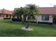 Condo building with lush landscaping and palm trees at 19029 Us Highway 19 N # 33A, Clearwater, FL 33764