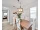 A view of the dining area with a table, chairs, light fixture, and view into a hallway at 1918 Overbrook Ave, Clearwater, FL 33755