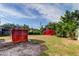 Spacious backyard with storage shed, greenery, and a walkway at 2008 Culberson Ave, Dunedin, FL 34698