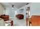 Living area with wood furniture, ceiling fan, and view into adjacent room at 2008 Culberson Ave, Dunedin, FL 34698