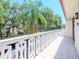 Spacious tiled balcony with decorative railings, offering serene views of the lush greenery at 2612 Pearce Dr # 304, Clearwater, FL 33764