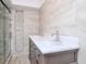 Bathroom showcasing double vanity and modern tiled walk-in shower at 2612 Pearce Dr # 304, Clearwater, FL 33764