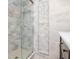 Nicely tiled bathroom featuring frameless glass shower and recessed shelving at 2612 Pearce Dr # 304, Clearwater, FL 33764