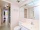Well-maintained bathroom featuring a vanity, toilet, and glass-enclosed shower, with classic wallpaper at 2612 Pearce Dr # 304, Clearwater, FL 33764