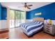 Comfortable bedroom with blue walls, sliding glass doors, and a relaxing atmosphere at 2612 Pearce Dr # 304, Clearwater, FL 33764