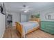 Cozy bedroom with wooden bed, green dresser, and ceiling fan at 3741 New River Rd, Wesley Chapel, FL 33543