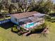 An aerial view of the home, pool, and lush backyard at 3741 New River Rd, Wesley Chapel, FL 33543