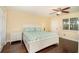 Bedroom with white bed and dark wood floors, and lots of natural light at 504 S Florida Ave # 212, Tarpon Springs, FL 34689