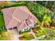 Aerial view of home, showcasing landscaped grounds, three-car garage, and tile roof, nestled among mature trees at 5212 Candler View Dr, Lithia, FL 33547