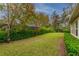 Long view of the backyard showing the lawn, trees, and landscaping at 5212 Candler View Dr, Lithia, FL 33547