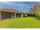 View of the backyard and screened porch from the lawn at 5212 Candler View Dr, Lithia, FL 33547