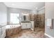 This bathroom features a glass-enclosed shower, a soaking tub, and a vanity with decorative lights at 5212 Candler View Dr, Lithia, FL 33547