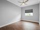 Empty bedroom featuring dark wood-look tile floors, gray walls, and white trim at 5212 Candler View Dr, Lithia, FL 33547