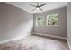 This is a bedroom with tile floors and two windows with views of the surrounding vegetation at 5212 Candler View Dr, Lithia, FL 33547