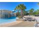 Resort style community pool with waterfall, palm trees and lounge chairs at 5212 Candler View Dr, Lithia, FL 33547