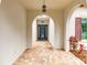 Inviting entryway with brick-paved floor, arched openings, and a decorative front door with glass detailing at 5212 Candler View Dr, Lithia, FL 33547