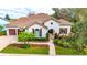 Charming home with arched entryway, tile roof, and well-maintained landscaping at 5212 Candler View Dr, Lithia, FL 33547