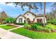 Front exterior of a single-story home with a tile roof, landscaped yard, and a walkway at 5212 Candler View Dr, Lithia, FL 33547