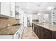 Modern kitchen featuring granite countertops, stainless appliances, and a stylish tile backsplash at 5212 Candler View Dr, Lithia, FL 33547