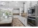 Elegant kitchen features granite countertops, tile backsplash, stainless steel appliances and ample cabinet space at 5212 Candler View Dr, Lithia, FL 33547