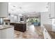 Open-concept living area with granite counters, island, stainless appliances, and bright living area with views of the yard at 5212 Candler View Dr, Lithia, FL 33547