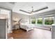 Comfortable main bedroom features a tray ceiling, large windows, and ample natural light at 5212 Candler View Dr, Lithia, FL 33547