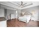 This main bedroom includes a bed, two nightstands with lamps, a dresser, and an ensuite bathroom at 5212 Candler View Dr, Lithia, FL 33547