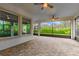 Covered patio area with beautiful paver flooring, large windows, and ceiling fans at 5212 Candler View Dr, Lithia, FL 33547