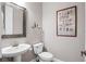 This powder room includes a pedestal sink, a framed mirror, and an artistic print on the wall at 5212 Candler View Dr, Lithia, FL 33547