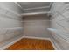 This walk-in closet features a wood floor and wire shelves to keep everything neatly organized at 5212 Candler View Dr, Lithia, FL 33547