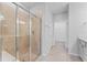 Modern bathroom with tiled shower, vanity, and walk-in closet access at 6421 Mooring Line Cir, Apollo Beach, FL 33572
