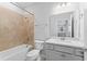 Bathroom with beige tile, white countertop, gray vanity, and a shower/tub combo at 6421 Mooring Line Cir, Apollo Beach, FL 33572
