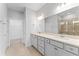 Spacious bathroom with double vanity, gray cabinets, and walk-in shower at 6421 Mooring Line Cir, Apollo Beach, FL 33572