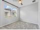 Empty bedroom with gray carpet, white walls, and a large window with blinds at 6421 Mooring Line Cir, Apollo Beach, FL 33572