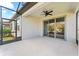 Covered patio with a ceiling fan and sliding doors leading to the backyard at 6421 Mooring Line Cir, Apollo Beach, FL 33572