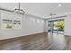 Spacious living room with wood-look flooring, a ceiling fan, and sliding glass doors leading to the backyard at 6421 Mooring Line Cir, Apollo Beach, FL 33572