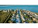 Aerial view of a waterfront home with private pool and canal access at 744 Jungle Queen Way, Longboat Key, FL 34228