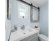 Bathroom with vanity, toilet, and a modern mirror at 744 Jungle Queen Way, Longboat Key, FL 34228