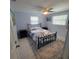 Cozy bedroom with a queen-size bed, ceiling fan, matching nightstands, and natural light at 744 Jungle Queen Way, Longboat Key, FL 34228