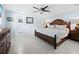 Spacious bedroom with wood bed frame, dresser, and ceiling fan at 744 Jungle Queen Way, Longboat Key, FL 34228