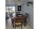 Dining room with a wooden table set, stylish light fixture, and sliding glass doors to the outside at 744 Jungle Queen Way, Longboat Key, FL 34228