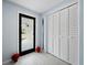 Entryway with etched glass door and white shutters at 744 Jungle Queen Way, Longboat Key, FL 34228