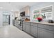 Modern kitchen with gray cabinets and granite countertops at 744 Jungle Queen Way, Longboat Key, FL 34228