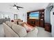 Living room with beige couches and wooden entertainment center at 744 Jungle Queen Way, Longboat Key, FL 34228